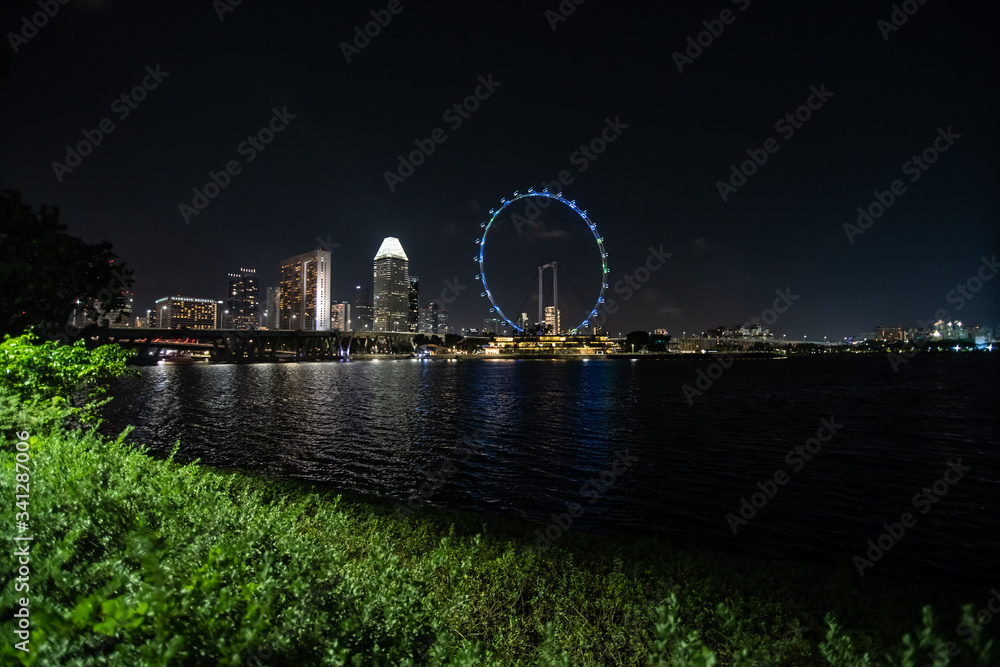 SINGAPORE - February, 2020: Skyline of Singapore with the Marina Bay Sands Luxury Hotel and the Singapore Flyer during a stunning sunset. Singapore is an island city-state off southern Malaysia.