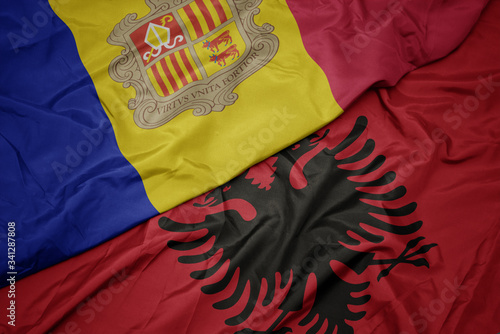 waving colorful flag of albania and national flag of andorra.