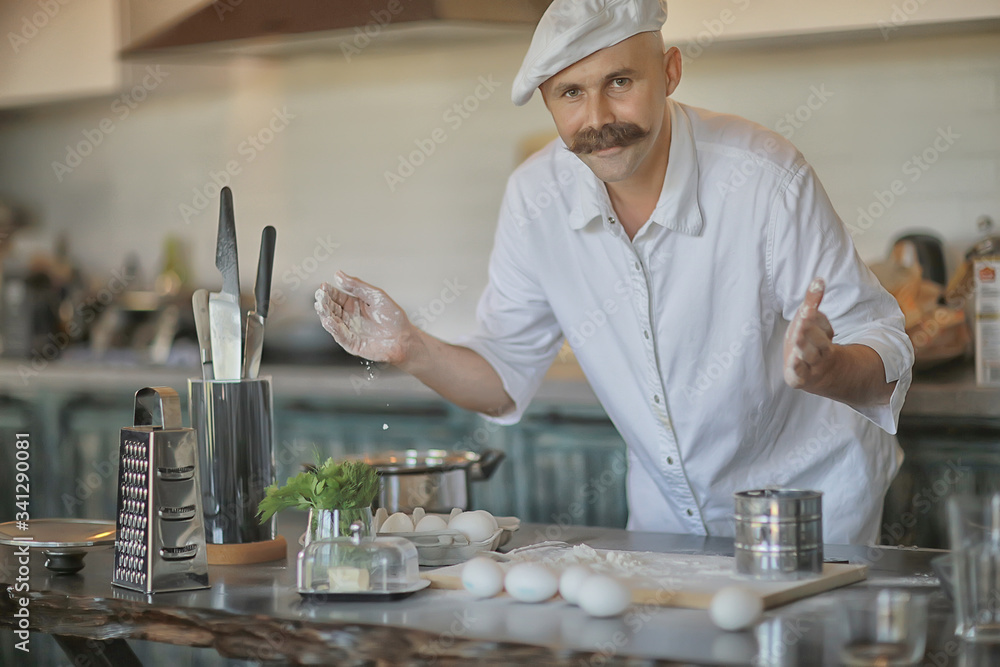 portrait of a cook, mustachioed male chef in a hat, profession