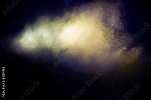 Fog on stage during a rock concert on a dark background.