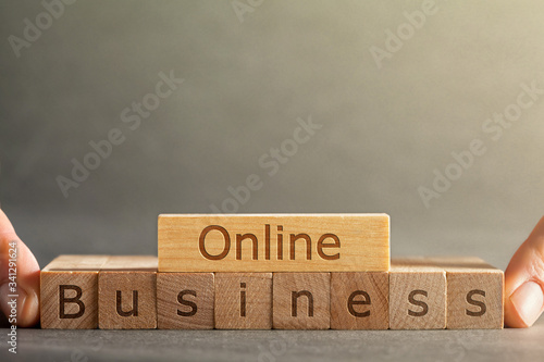 Wallpaper Mural a online business inscription engraved on blocks that hold fingers on a gray background Torontodigital.ca