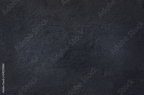 surface of the stucco wall in a dark blue tone.