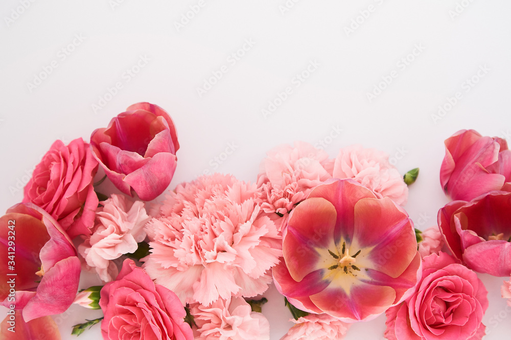 top view of pink spring flowers on white background with copy space top view of pink spring flowers on white background with copy space