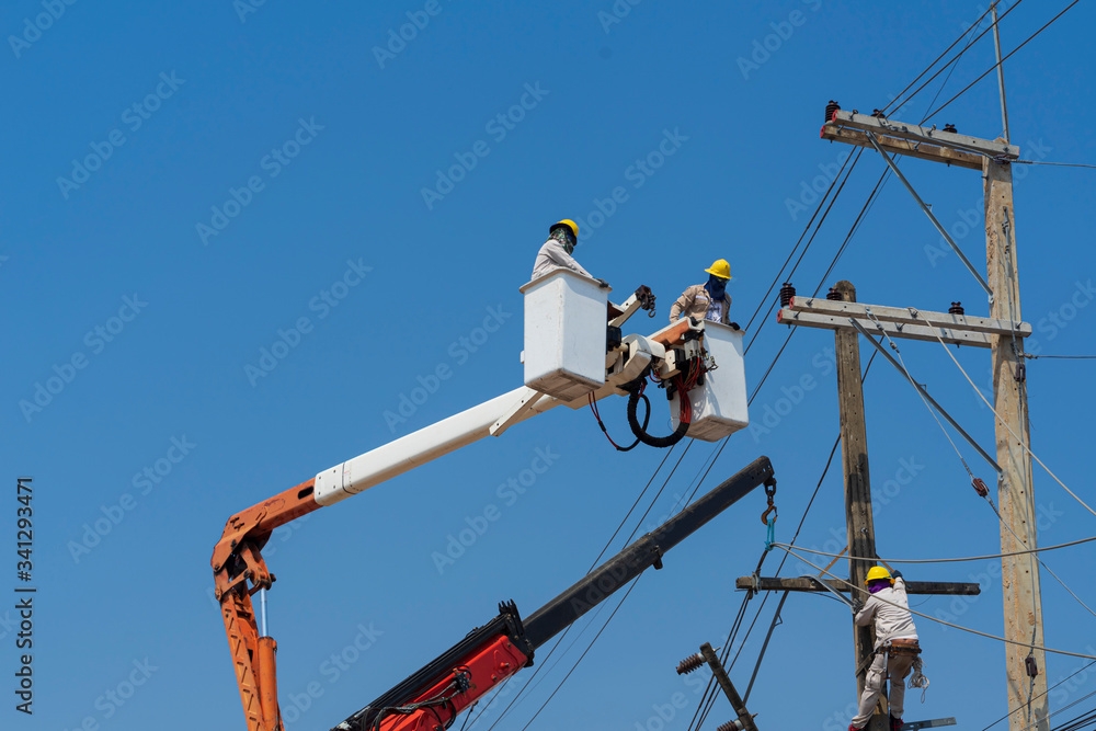 Electricians install equipment in the high-voltage system.