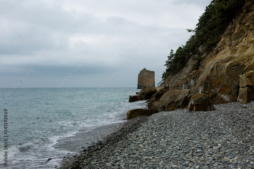 Stones beach at the sea in dark day