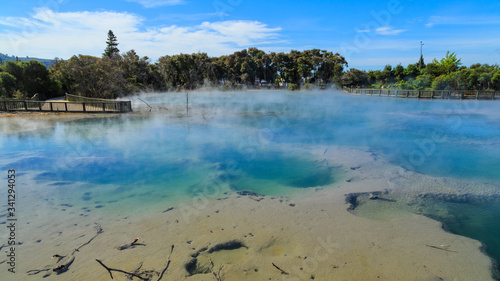 The steaming hot geothermal lake at Kuirau Park, Rotorua, New Zealand, surrounded by a wooden walkway