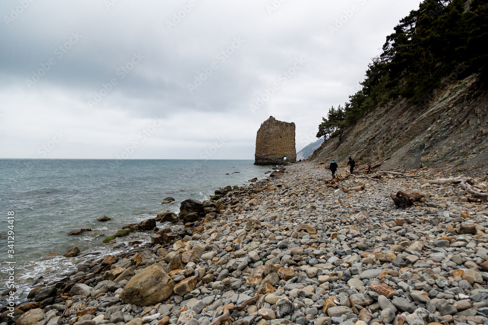 Stones beach at the sea in dark day