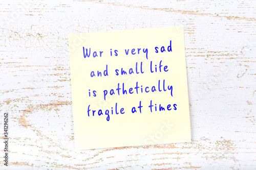 Yellow sticky note with handwritten motivational quote photo