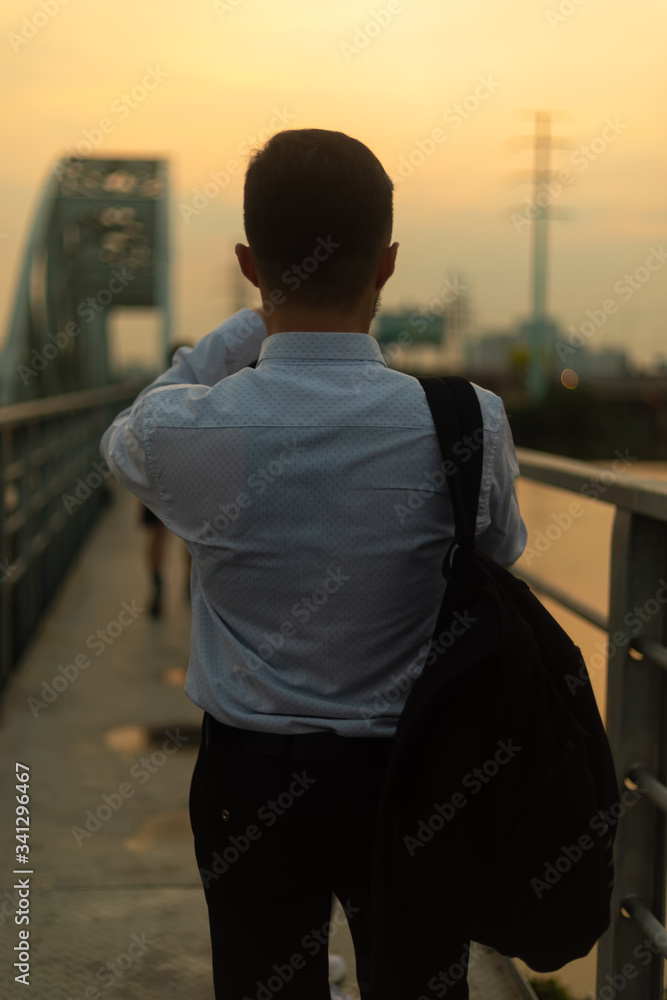 Fototapeta premium Man poses on an old bridge.