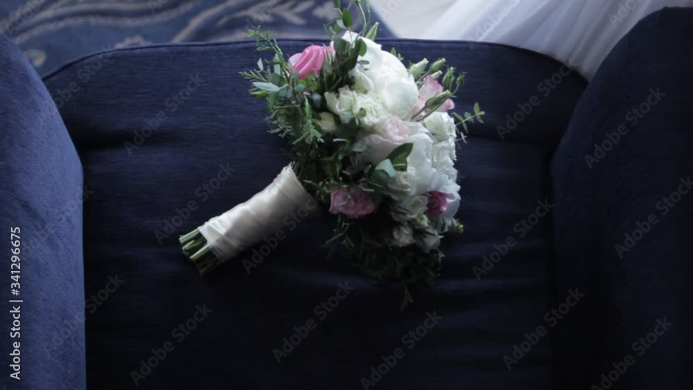 the bride's flower bouquet is lying on the chair the bride's flower bouquet is lying on the chair
