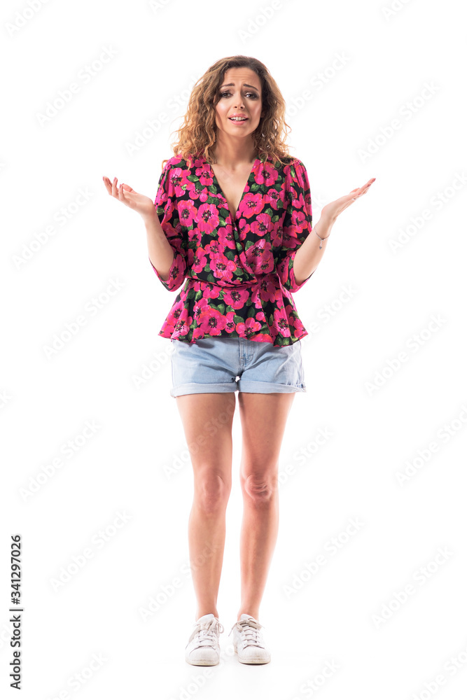 Stressed sad misunderstood young woman trying to explain looking at camera almost crying. Full body isolated on white background. Stressed sad misunderstood young woman trying to explain looking at camera almost crying. Full body isolated on white background.
