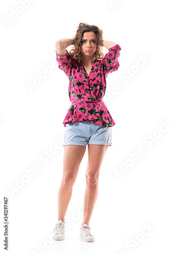 Frustrated sulking young cute woman holding head with hands having migraine and rolling eyes annoyed. Full body isolated on white background. 