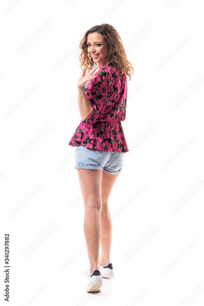 Back view of happy young woman in casual clothes walking away turning at camera and waving goodybe. Full body isolated on white background. Back view of happy young woman in casual clothes walking away turning at camera and waving goodybe. Full body isolated on white background.