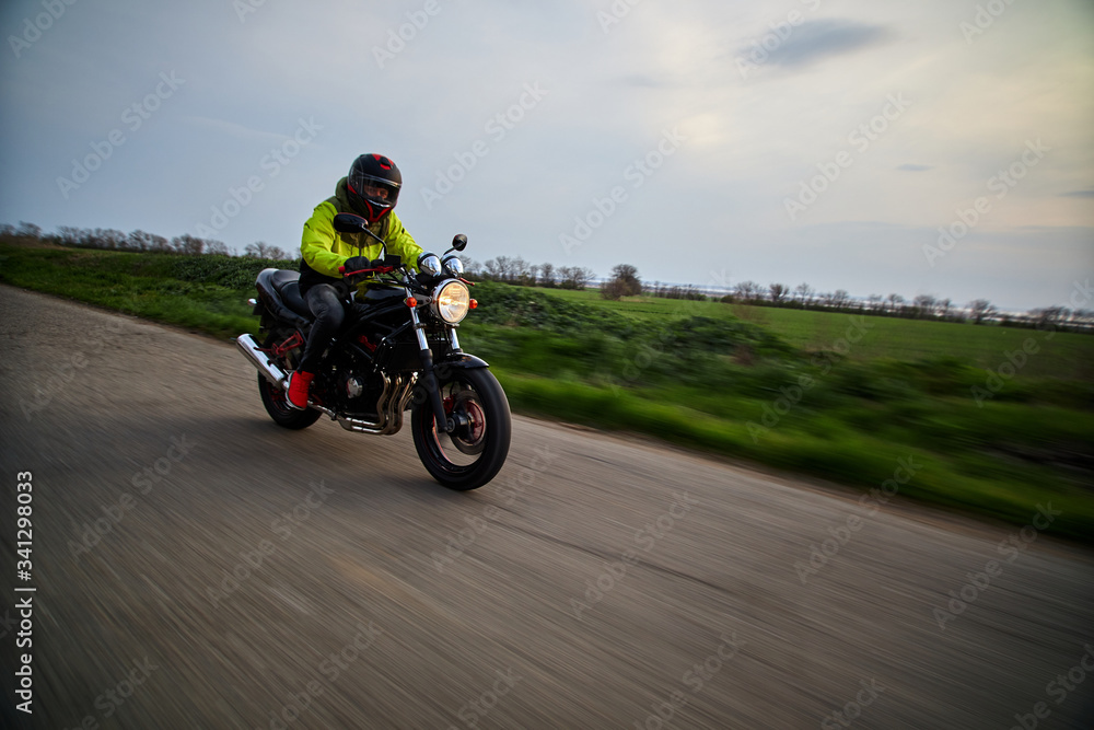 man rides a motorcycle on a highway