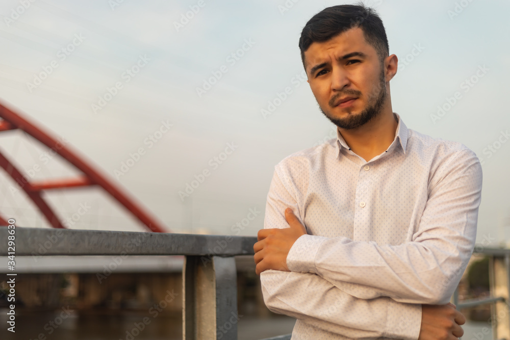 Man poses on an old bridge. Man poses on an old bridge.