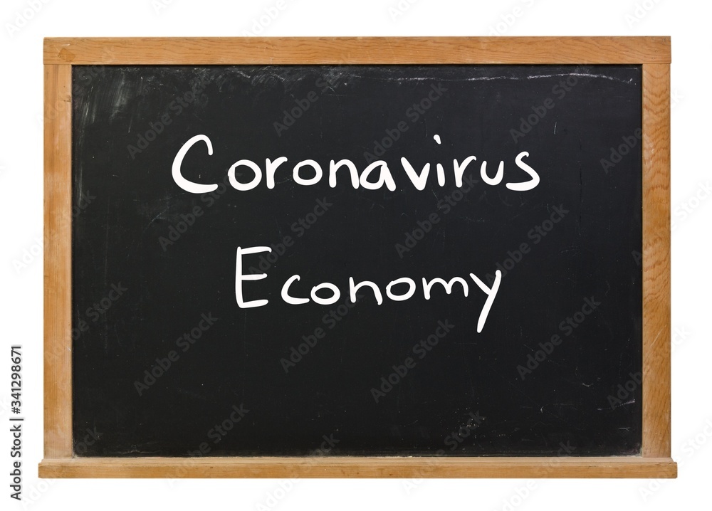 Coronavirus economy written in white chalk on a black chalkboard isolated on white Coronavirus economy written in white chalk on a black chalkboard isolated on white