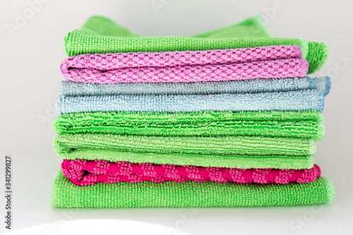 multi-colored rags for cleaning on a white background
