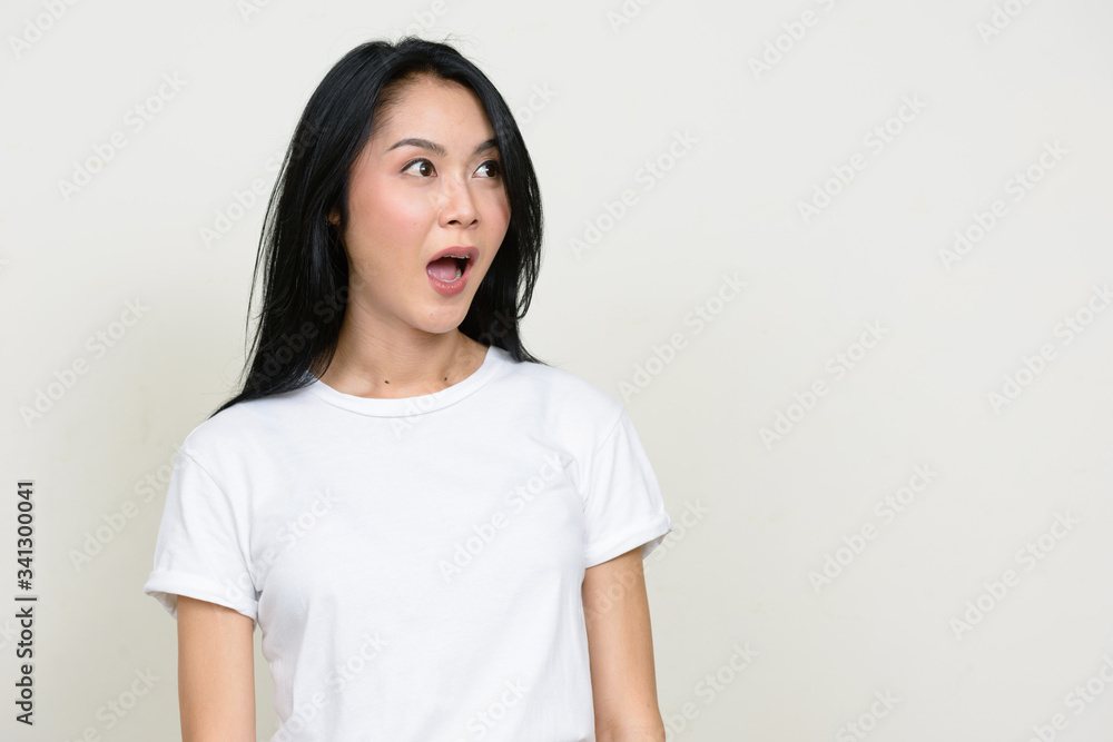 Portrait of young beautiful Asian woman looking shocked Portrait of young beautiful Asian woman looking shocked