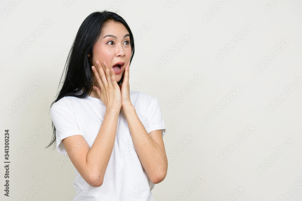Portrait of young Asian woman looking shocked Portrait of young Asian woman looking shocked