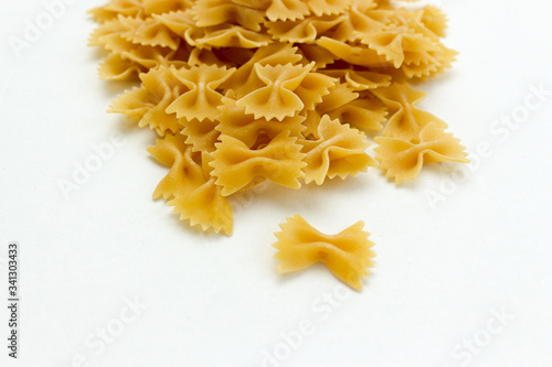heap of bow tie pasta on white background