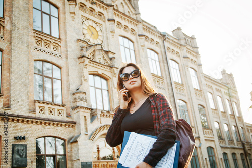 student girl near the university building © Amakar