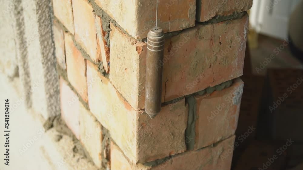 builder measures the evenness of the wall builder measures the evenness of the wall