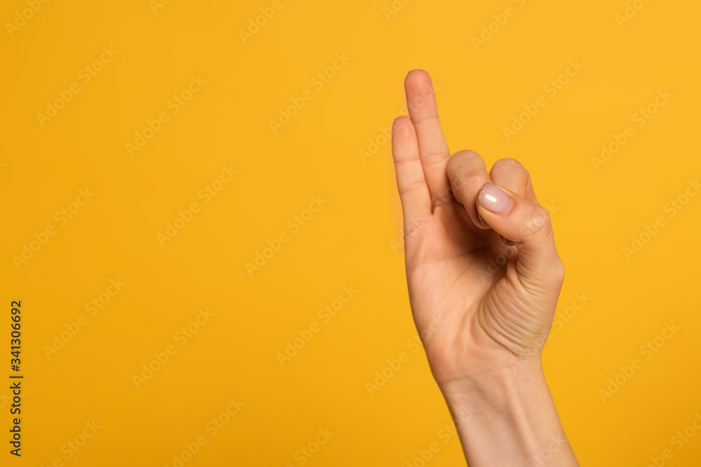 Naklejka premium Cropped view of woman using sign language isolated on yellow