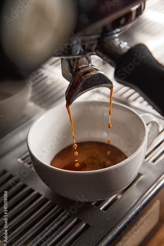 Coffee machine makes coffee. Pours into a cup