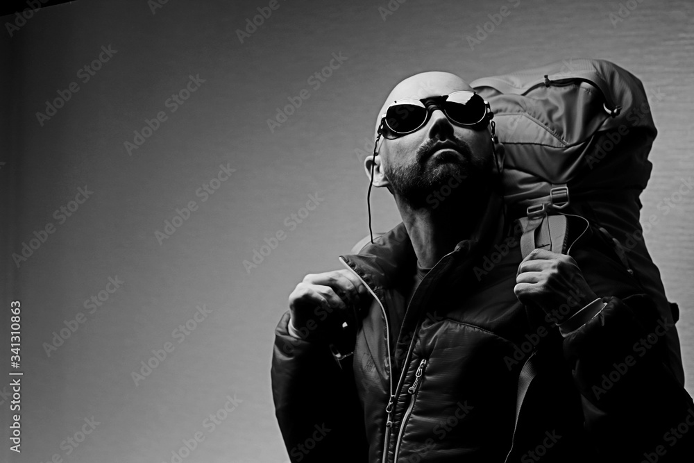 Tourist bearded man in sunglasses, sport tourism, concept active leisure, male tourism, portrait of a brutal man in sportswear, middle-aged man