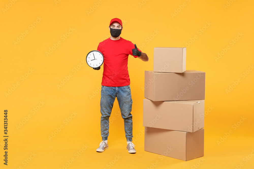 Delivery man employee in red cap blank t-shirt uniform face mask glove hold empty cardboard box isolated on yellow background studio Service quarantine pandemic coronavirus flu virus 2019-ncov concept Delivery man employee in red cap blank t-shirt uniform face mask glove hold empty cardboard box isolated on yellow background studio Service quarantine pandemic coronavirus flu virus 2019-ncov concept