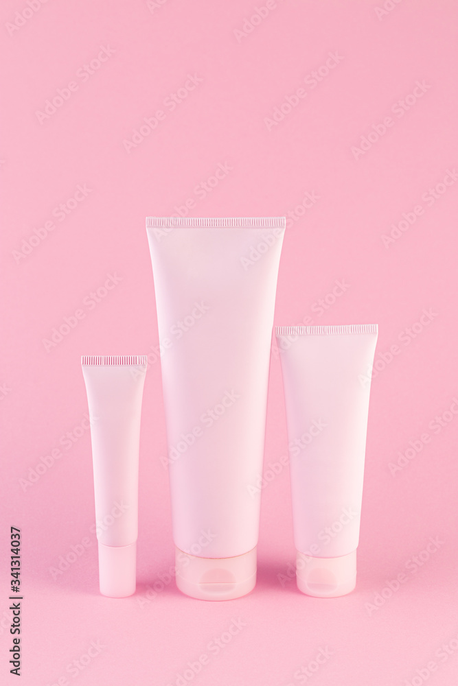 Collection of three cosmetic tubes on pastel pink background. Plastic tube with face or body cream on pink with copy space. plastic tube for medicine or cosmetics cream, gel, skin care, toothpaste. Collection of three cosmetic tubes on pastel pink background. Plastic tube with face or body cream on pink with copy space. plastic tube for medicine or cosmetics cream, gel, skin care, toothpaste.