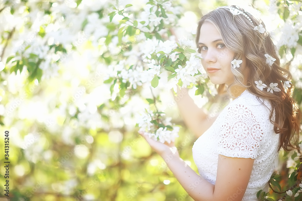Fototapeta premium spring girl apple flowers, nature portrait of happy girl with long hair in blooming apple trees, freedom purity concept of happiness