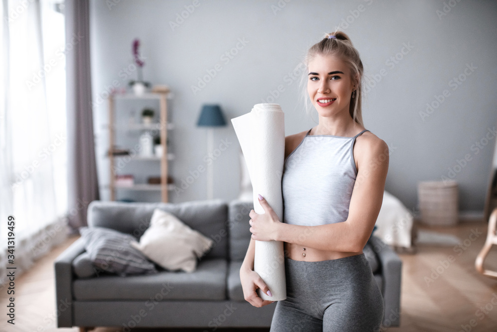 Athletic woman with yoga mat indoors. Athletic woman with yoga mat indoors.