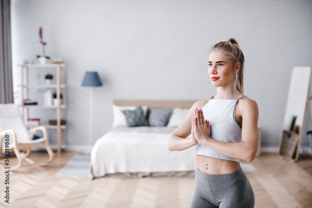 Beautiful young woman practicing yoga at home. Beautiful young woman practicing yoga at home.