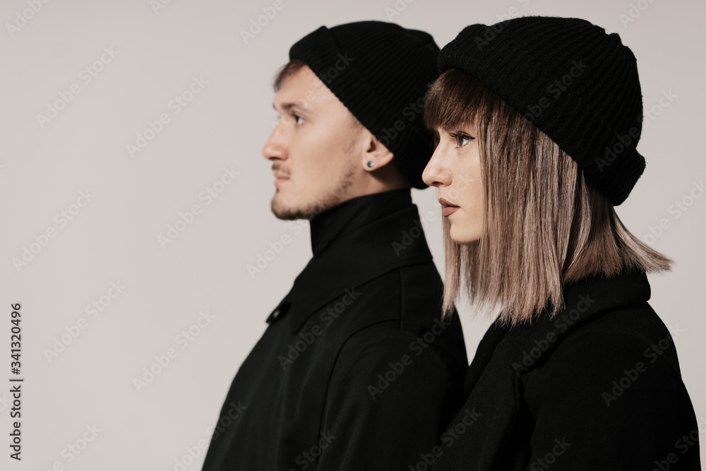 Portrait of urban fashion beautiful couple in black clothes posing over white background together. Close up fashion portrait of stylish young couple pretty woman and handsome man Portrait of urban fashion beautiful couple in black clothes posing over white background together. Close up fashion portrait of stylish young couple pretty woman and handsome man