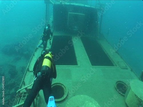 Wallpaper Mural scuba divers exploring the ship wreck underwater ocean scenery of shipwreck Torontodigital.ca