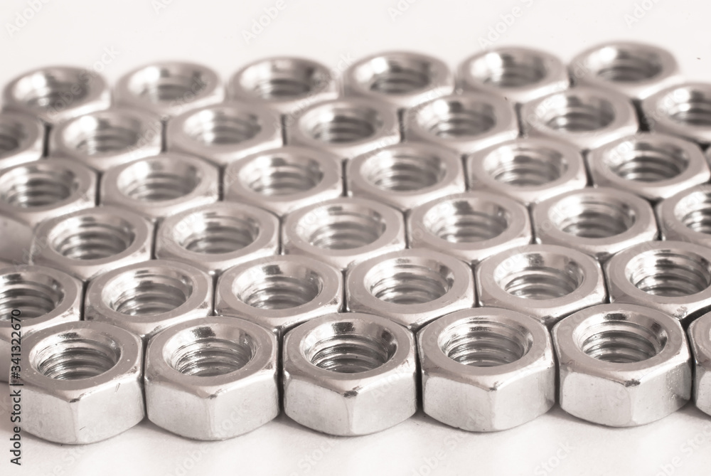 Screw, bolt and nut in black and white for industrial background. Pattern of metal nuts. Metal nuts on white background. Chromed nuts isolated. Steel nuts isolated. Tools for work Screw, bolt and nut in black and white for industrial background. Pattern of metal nuts. Metal nuts on white background. Chromed nuts isolated. Steel nuts isolated. Tools for work