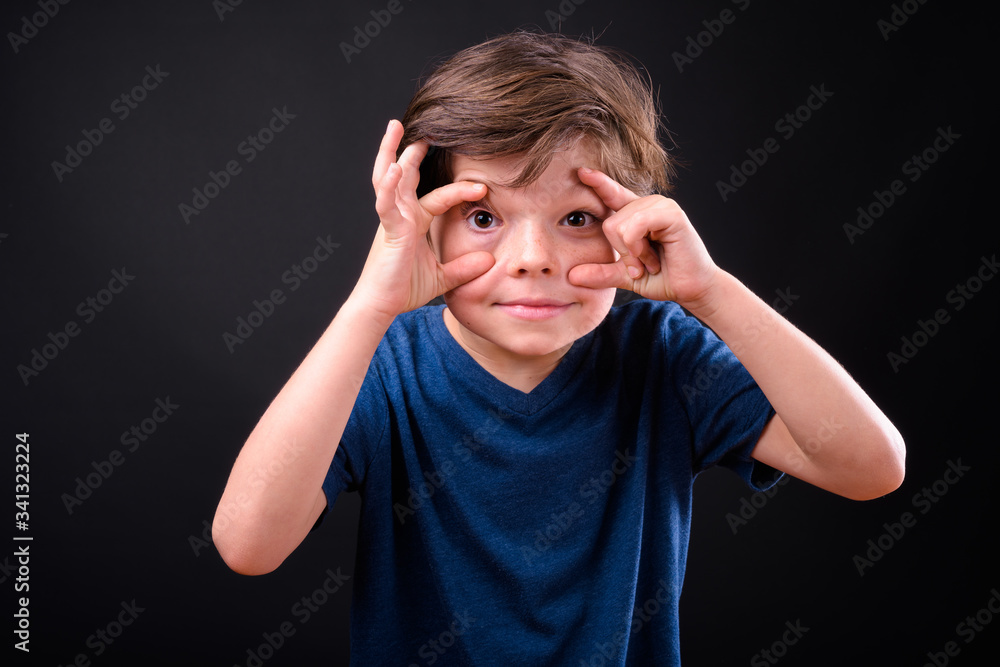 Portrait of young handsome boy making eyes big Portrait of young handsome boy making eyes big