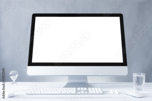 Computer all in one mockup, home and office workspace concept. Computer white blank screen on work table front view. Copy space