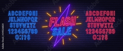 Flash sale neon sign. Neon alphabet on brick wall background.