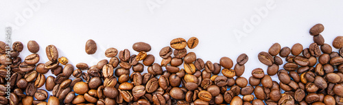 coffee beans evenly sprinkled on a white background