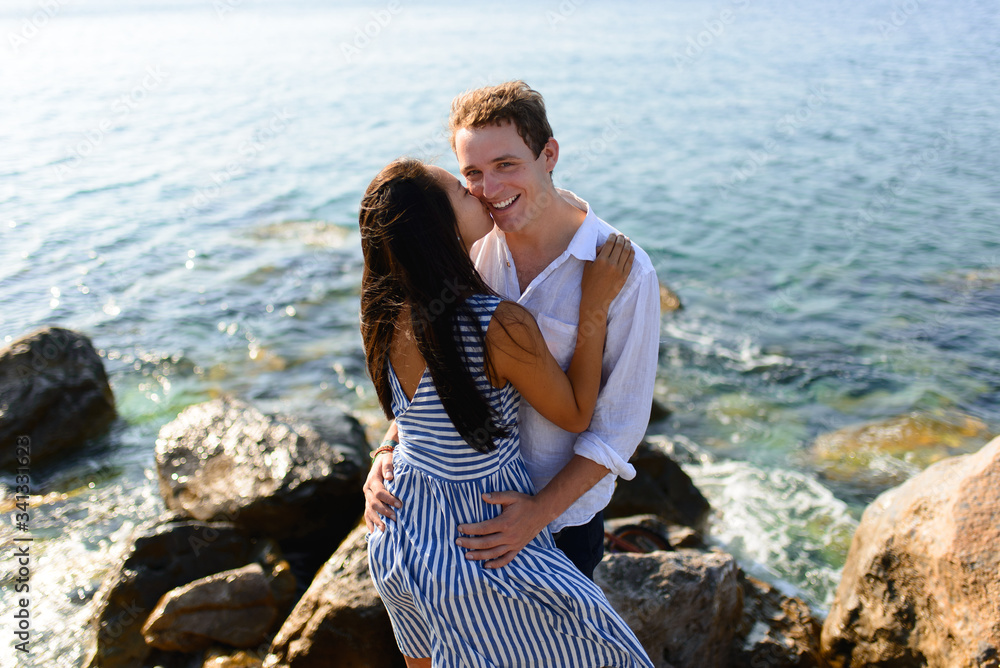 Young beautiful couple kissing on sea background. Young beautiful couple kissing on sea background.