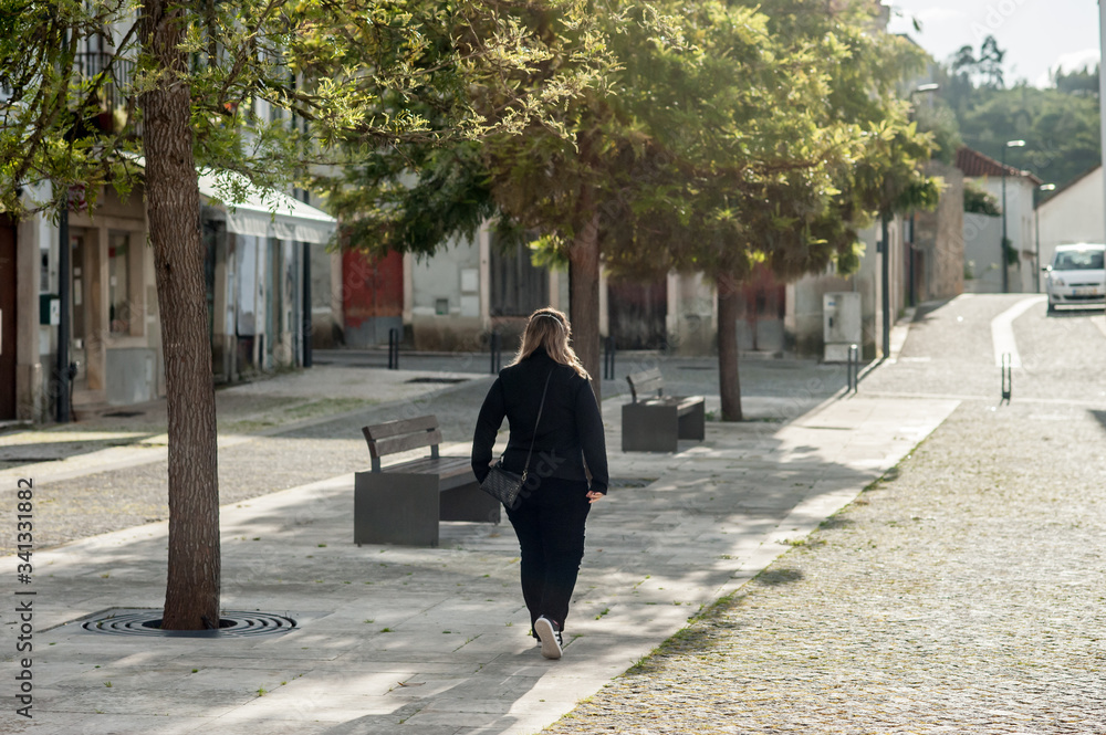lonely woman walking on the empty street.