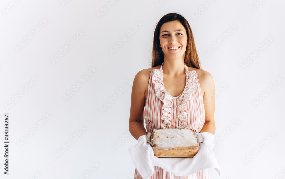 Caucasian woman is holding charlotte pie in her hands on white background close up. Home made pie. Caucasian woman is holding charlotte pie in her hands on white background close up. Home made pie.