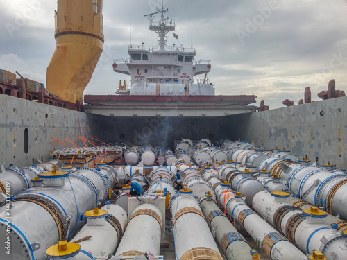 cargo hold of loaded vessel with pipes and construction