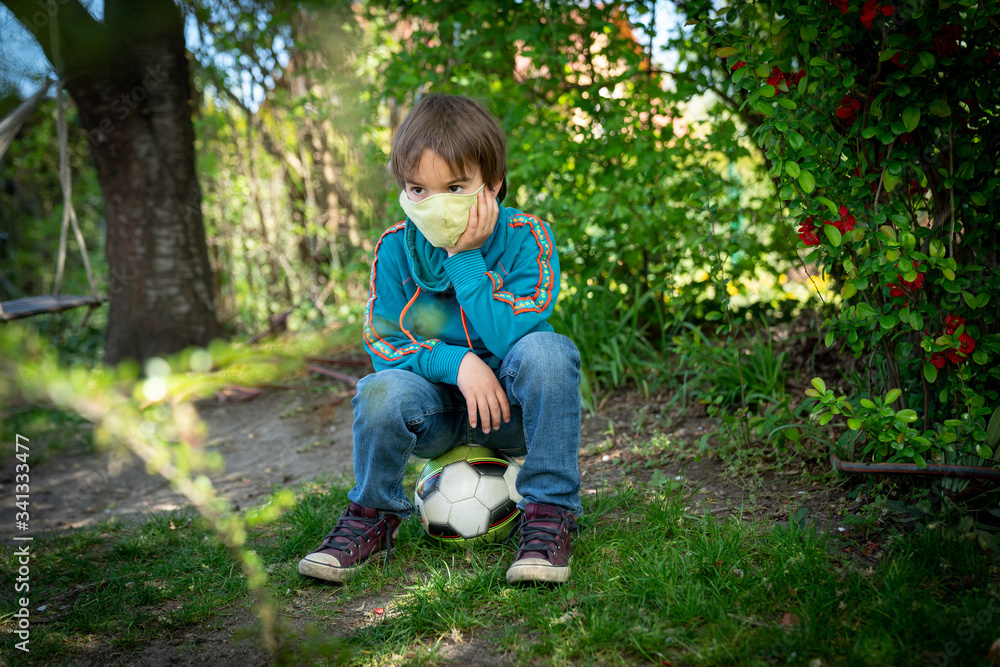Child with face mask is playing with a ball Child with face mask is playing with a ball