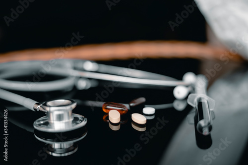 Stethoscope with medicine on table, Medicine and health care concept.