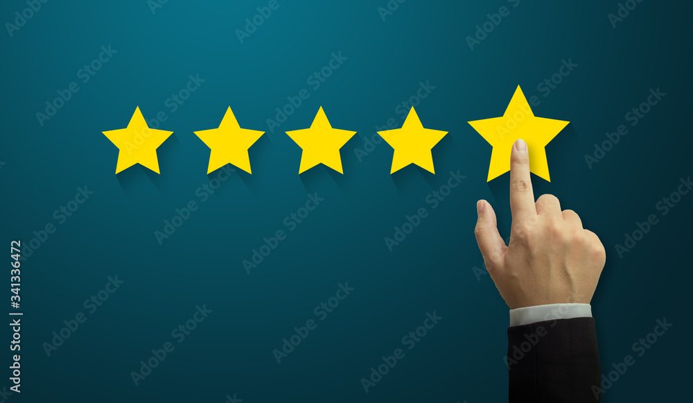 Hand of businessman touching five star symbol to increase rating of company concept, Copy space background for your title Hand of businessman touching five star symbol to increase rating of company concept, Copy space background for your title