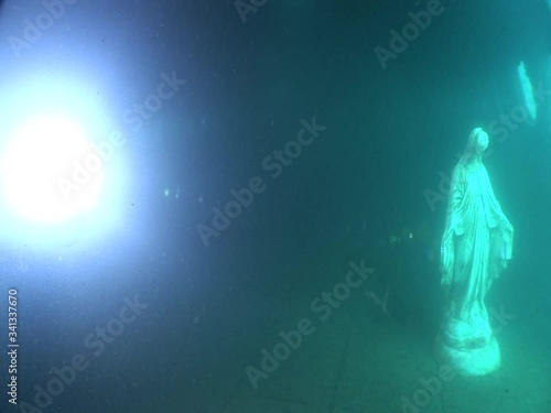 mother Mary statue underwater in an airplane wreck  ocean scenery photo