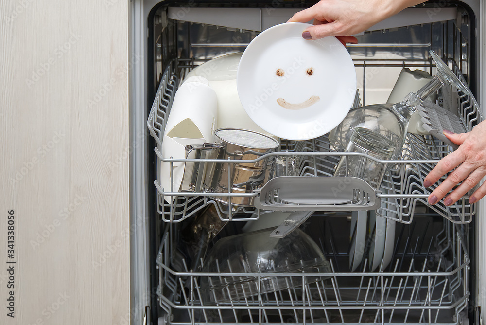 Fine washed dishes in the dishwasher. Integrated Dishwasher with white